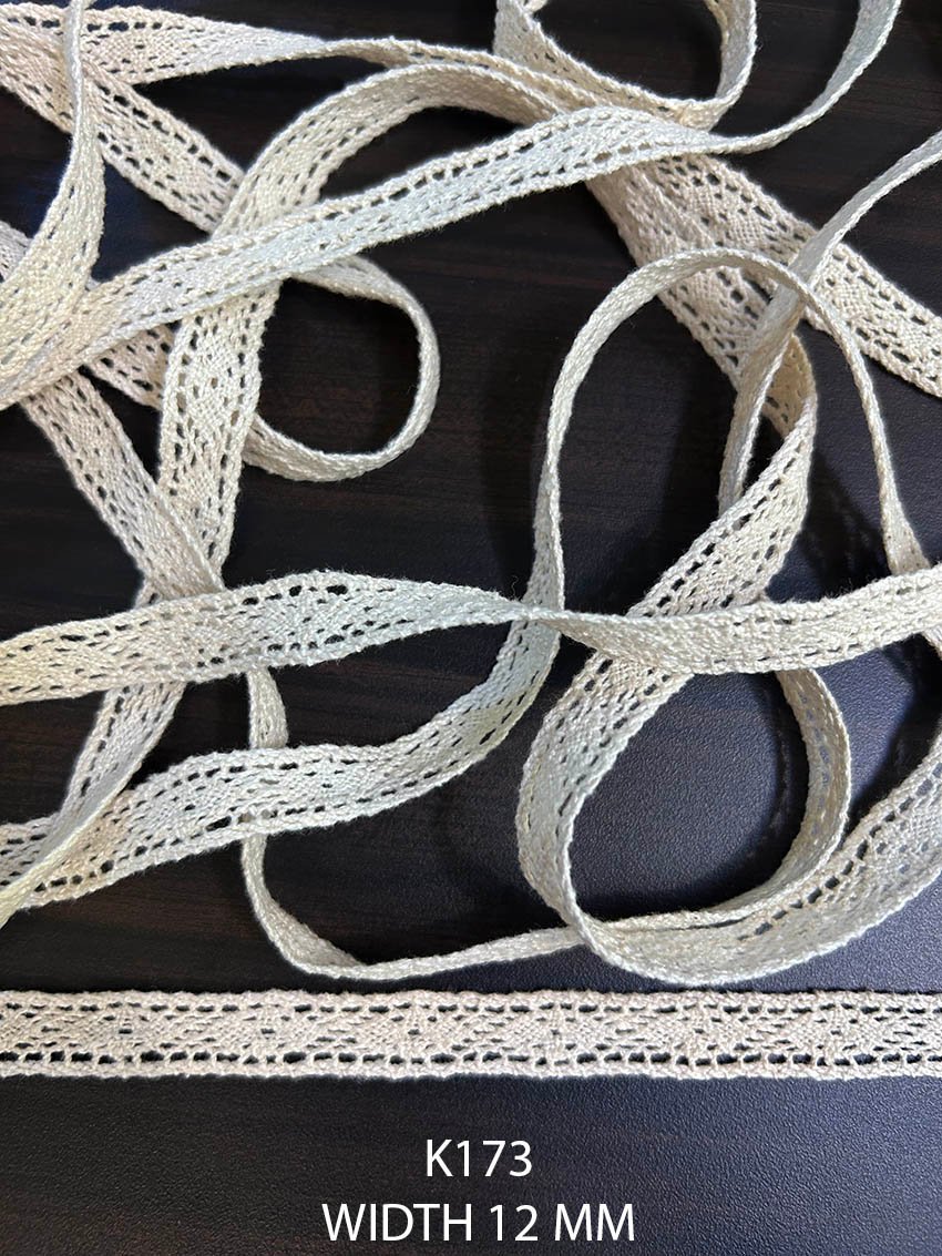 K173 12 mm greige dyeable cotton edging with narrow perforated woven pattern
