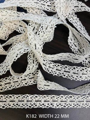 Shop K78 white fine crochet lace in 30 MM width, featuring a graceful linear floral motif with airy meshwork. Ideal for apparel and sewing projects.