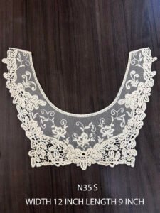 Close-up of N35S cotton GPO net neck appliqué featuring intricate floral lace patterns