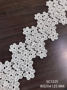 Close-up of SC1225 GPO white lace with floral embroidery