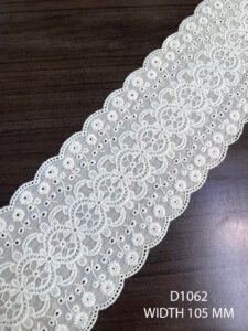 White embroidered lace trim with fine detailing and dual scalloped edges, 105 mm width