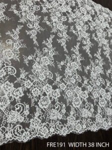 Close-up of FRE191 Chantilly eyelash lace fabric with delicate floral motifs and soft eyelash edges, 38-inch wide