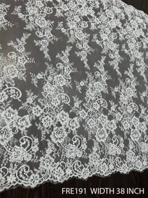 Close-up of FRE191 Chantilly eyelash lace fabric with delicate floral motifs and soft eyelash edges, 38-inch wide
