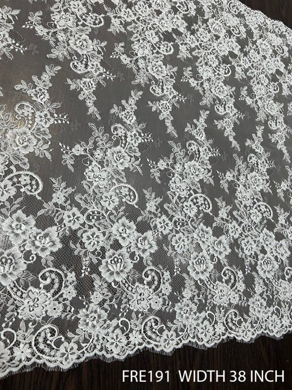 Close-up of FRE191 Chantilly eyelash lace fabric with delicate floral motifs and soft eyelash edges, 38-inch wide