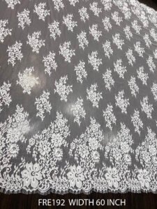FRE192 Chantilly lace fabric with intricate floral design and eyelash edges, 60-inch wide, ideal for bridal and couture garments