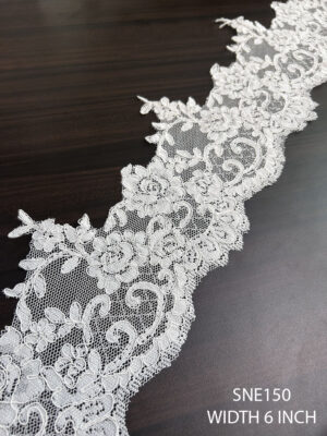 Detailed view of SNE150 net embroidered cording lace with 6-inch width for garment borders.