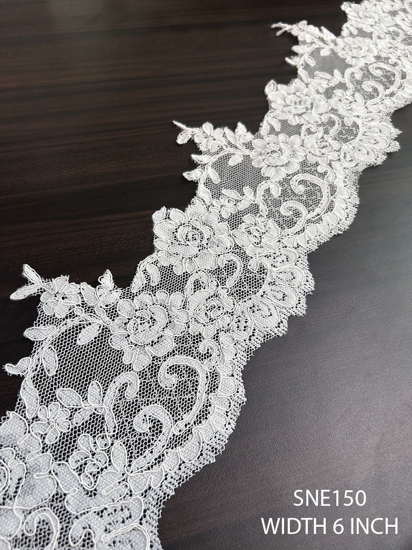 Detailed view of SNE150 net embroidered cording lace with 6-inch width for garment borders.