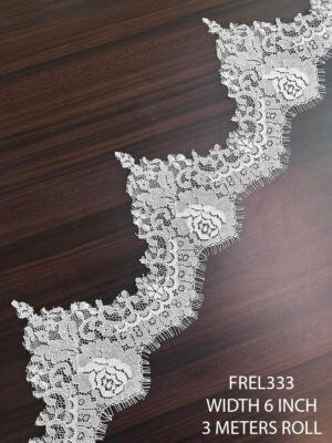 Premium white Chantilly eyelash lace trim featuring elegant floral embroidery and scalloped eyelash edges for bridal couture designs.