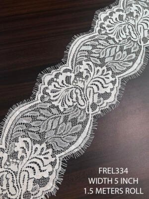 Premium white Chantilly eyelash lace trim with elegant floral motifs and fine net structure for bridal and couture fashion applications.