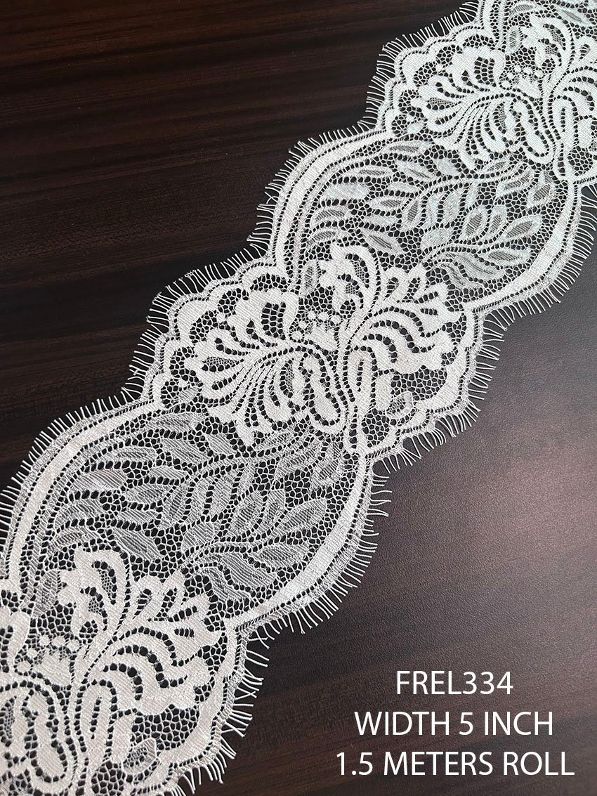 Premium white Chantilly eyelash lace trim with elegant floral motifs and fine net structure for bridal and couture fashion applications.